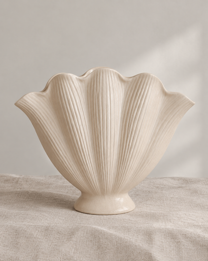 Cream Ribbed Scallop Shell Ceramic Vase, shown alone on a linen background