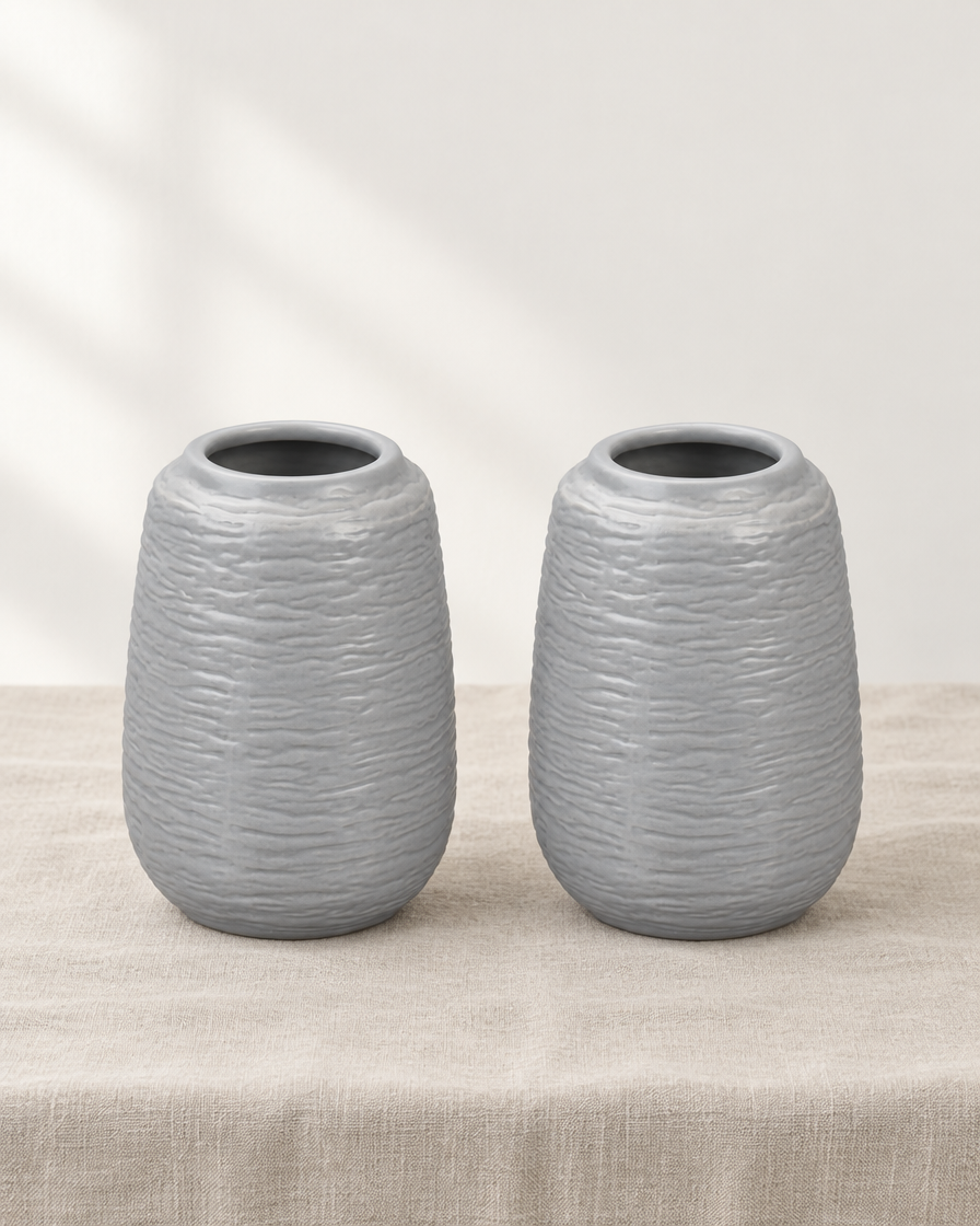 Set of 2 Grey Embossed Ceramic Vases, shown alone on a linen background