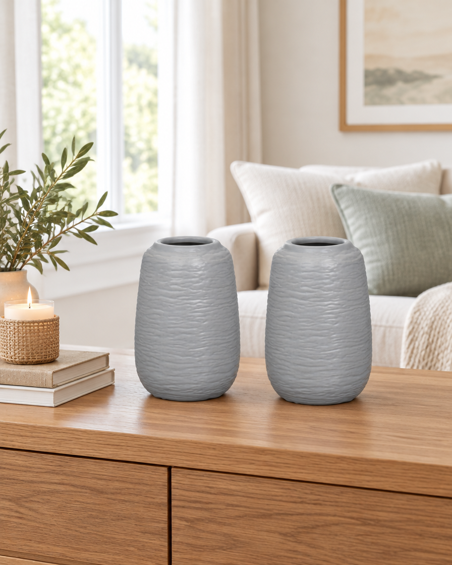 Set of 2 Grey Embossed Ceramic Vases on a console table