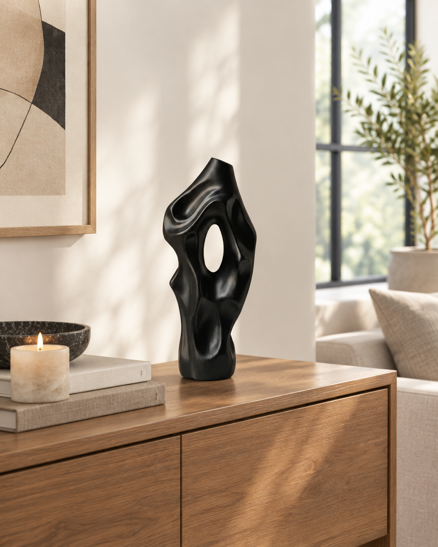 Black Abstract Organic Sculptural Vase with Hollow Opening on a console table