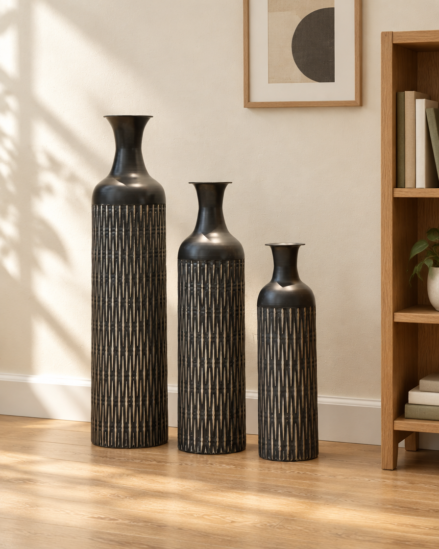 Set of 3 Black Etched Floor Vases beside a wooden shelf