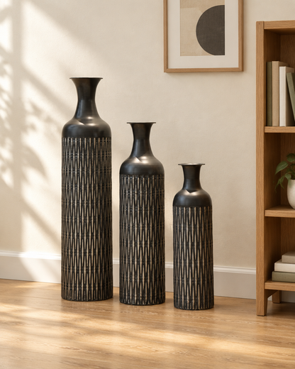 Set of 3 Black Etched Floor Vases beside a wooden shelf