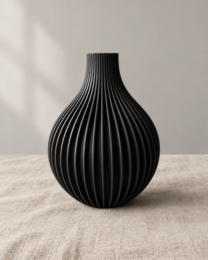 Black Ribbed Teardrop Vase, shown alone on a linen background