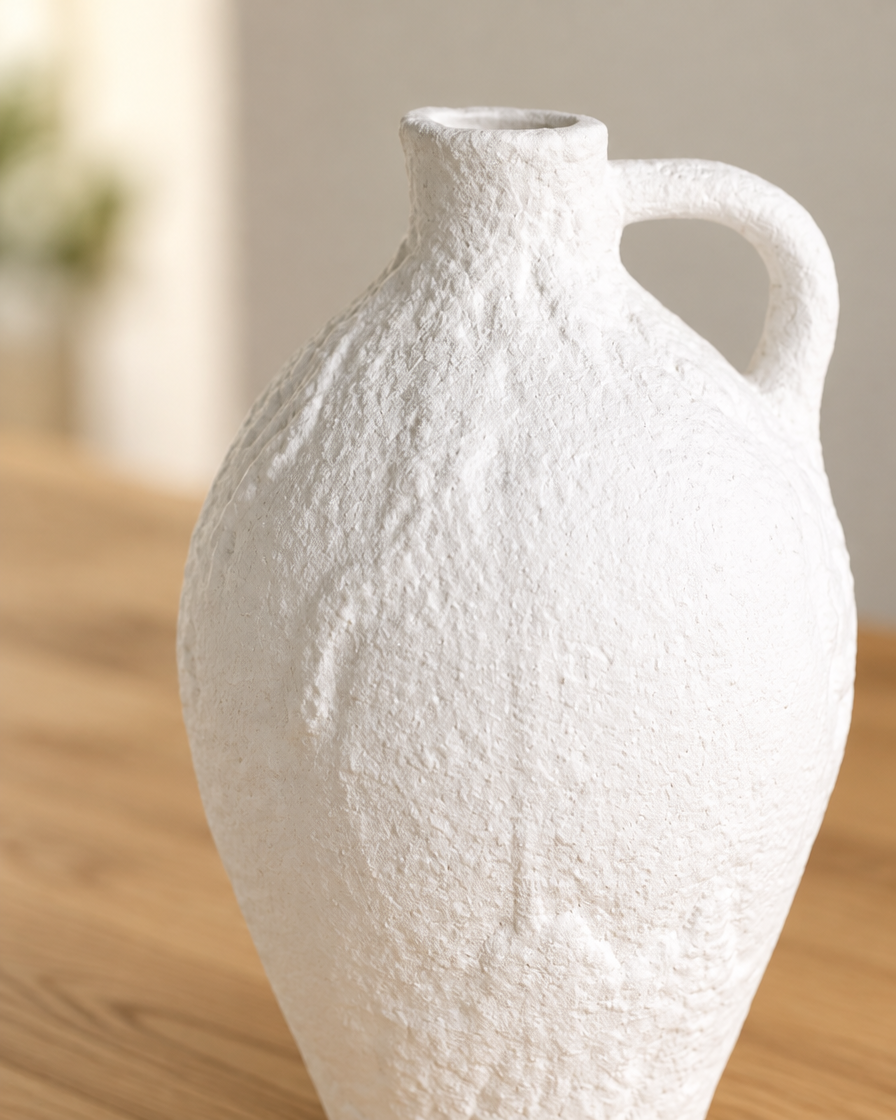 Close-up of the finish of the white textured ceramic jug vase with handle