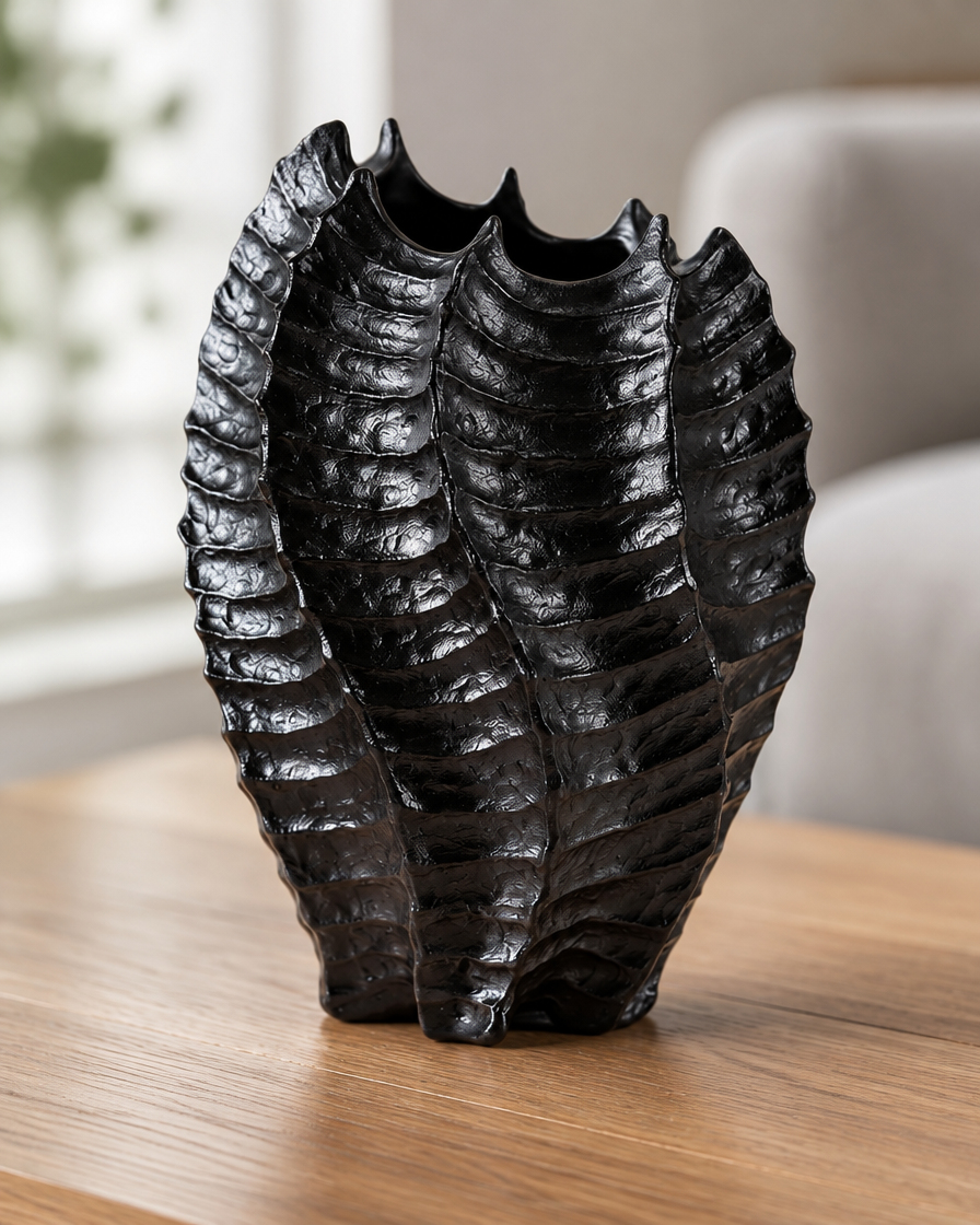 Close-up of the finish of the black glossy ribbed coral-shaped vase