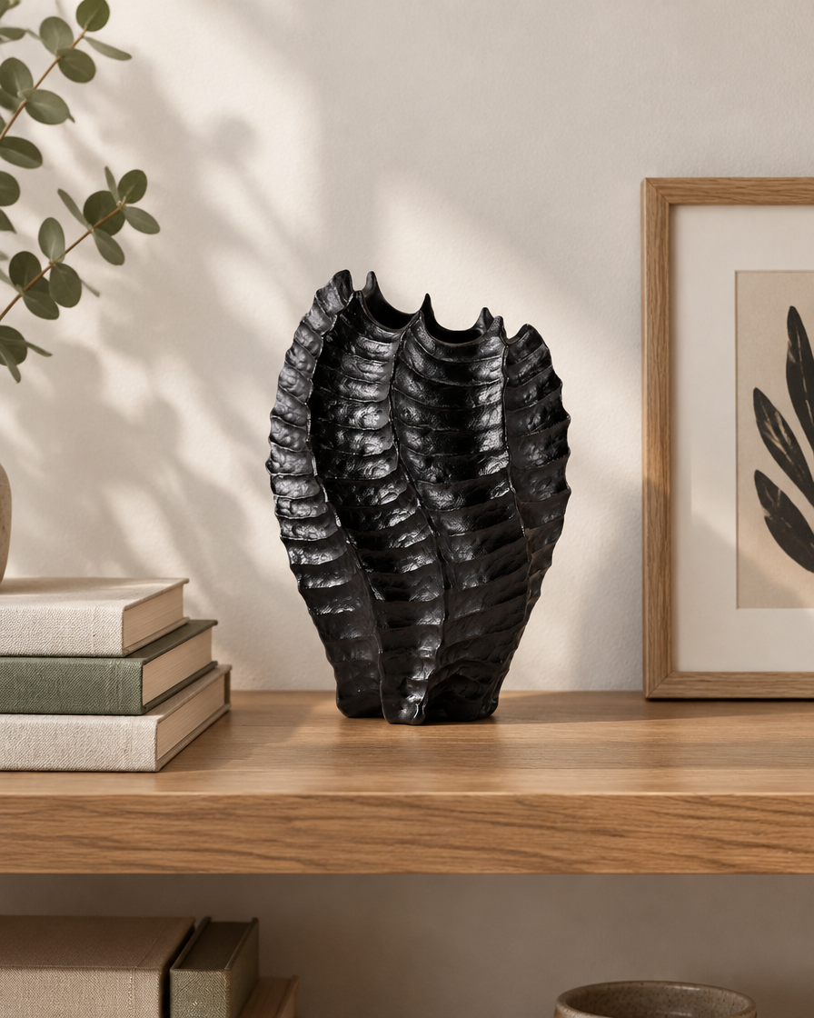 Black Glossy Ribbed Coral-Shaped Vase on a wooden shelf