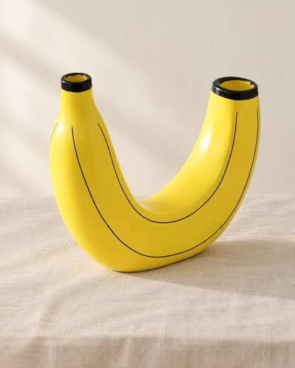 Yellow Banana-Shaped Resin Vase, shown alone on a linen background