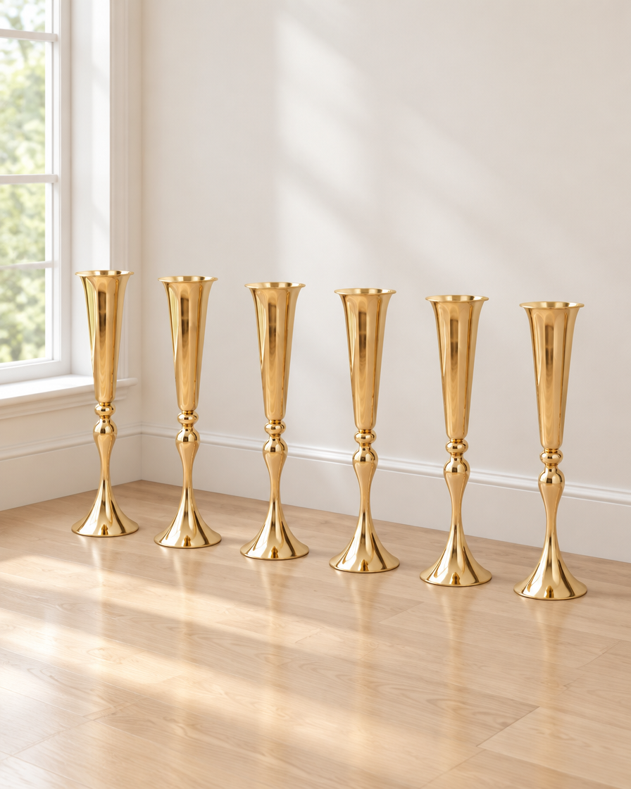 Set of 6 Gold Trumpet Vases standing on the floor by a window