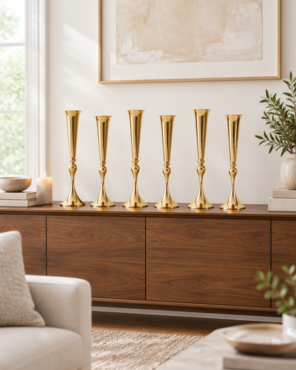 Set of 6 Gold Trumpet Vases lined up on a sideboard