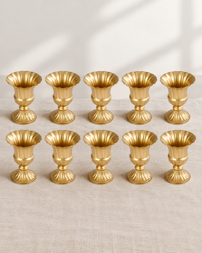 Set of 10 Gold Fluted Urn Vases, shown alone on a linen background