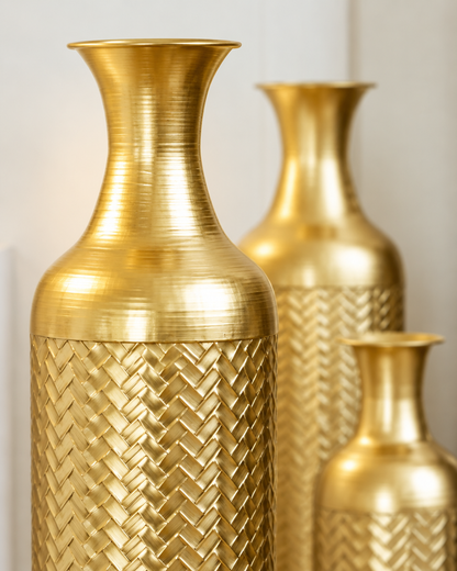 Close-up of the finish of the set of 3 gold textured metal floor vases