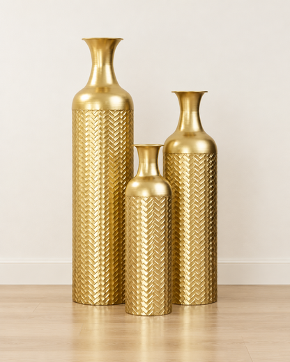 Set of 3 Gold Textured Metal Floor Vases, shown alone against a plain wall