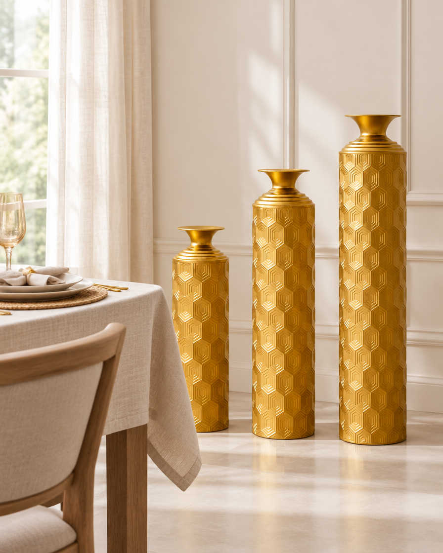 Set of 3 Gold Honeycomb-Texture Metal Floor Vases beside a dining table