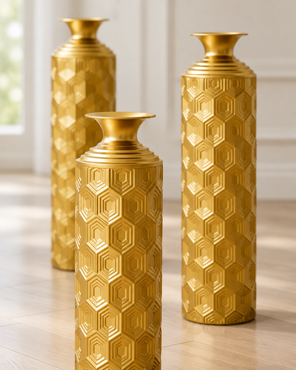 Close-up of the finish of the set of 3 gold honeycomb-texture metal floor vases