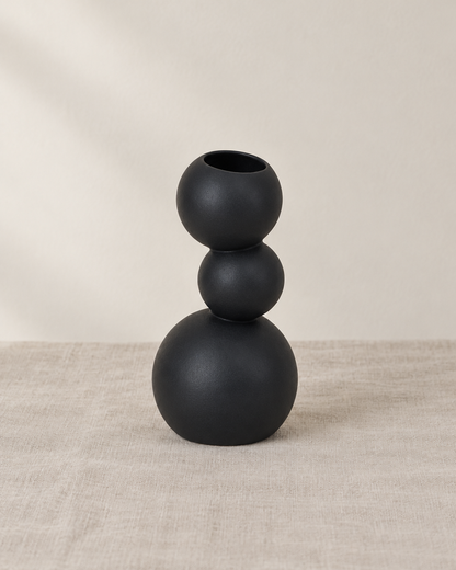 Black Stacked Ball Ceramic Vase, shown alone on a linen background