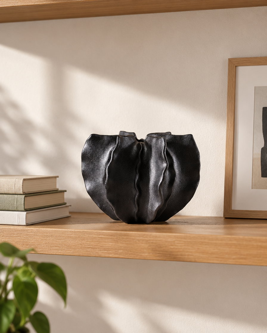 Black Folded Ruffle Ceramic Vase on a wooden shelf