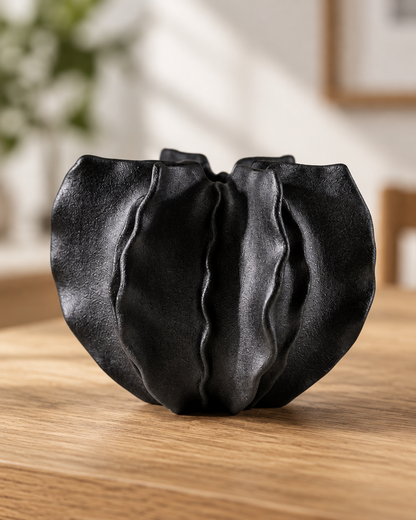 Close-up of the finish of the black folded ruffle ceramic vase