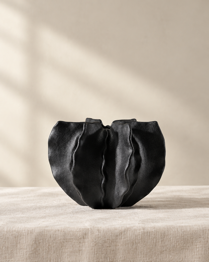 Black Folded Ruffle Ceramic Vase, shown alone on a linen background