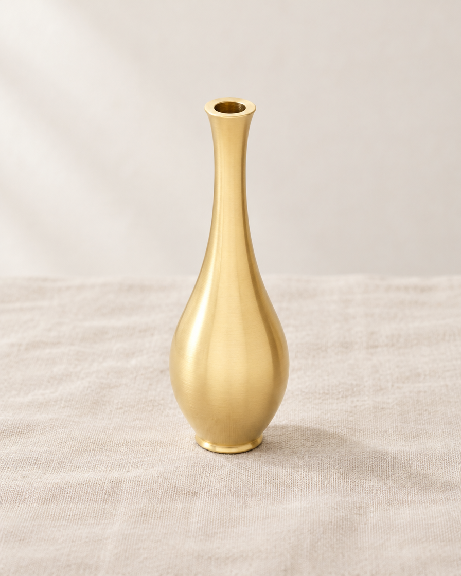 Mini Brushed Gold Metal Bud Vase, shown alone on a linen background
