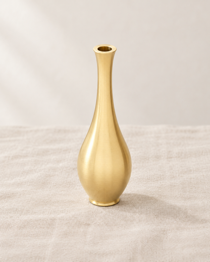 Mini Brushed Gold Metal Bud Vase, shown alone on a linen background