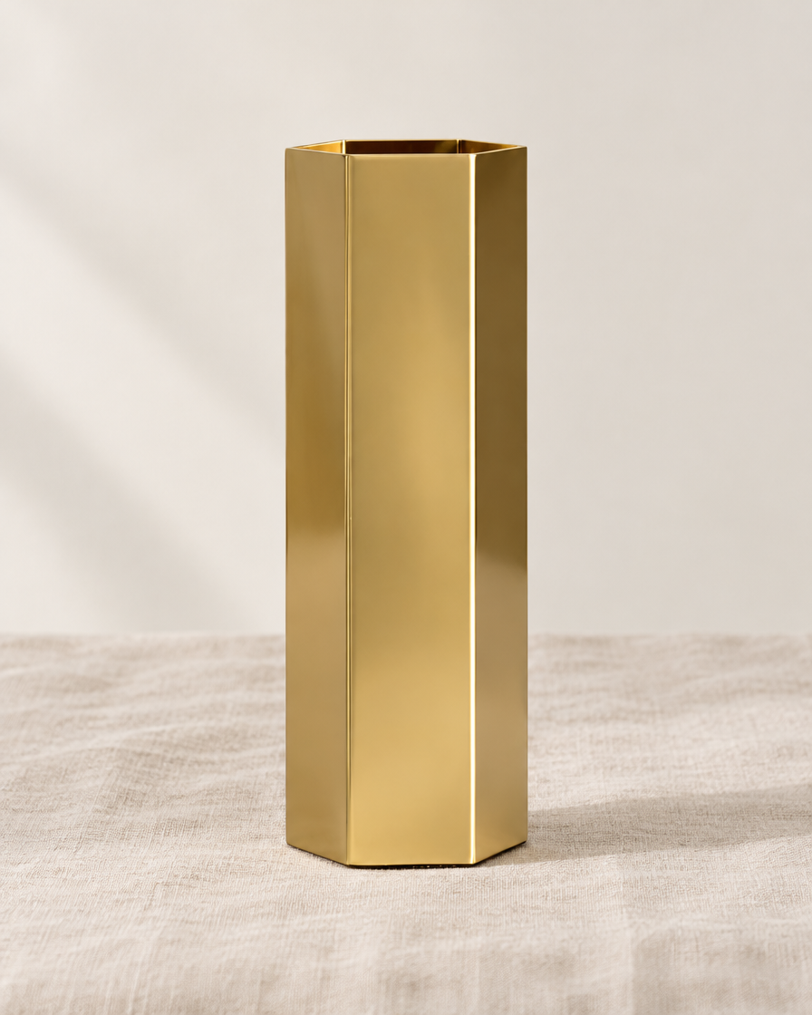 Brass-Tone Hexagonal Metal Vase, shown alone on a linen background