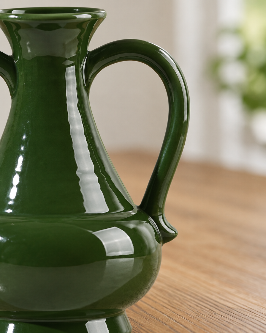 Close-up of the finish of the glossy deep green two-handled vase