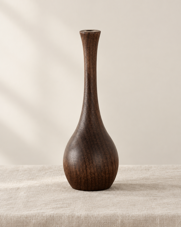 Slim Dark Wood Bottle Vase, shown alone on a linen background