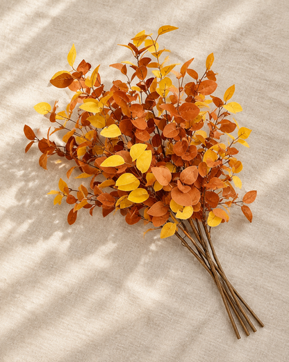 Rust Orange Artificial Autumn Eucalyptus Stems, shown alone on a linen background
