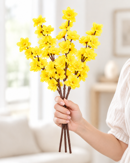 Yellow Artificial Blossom Branches held in a hand
