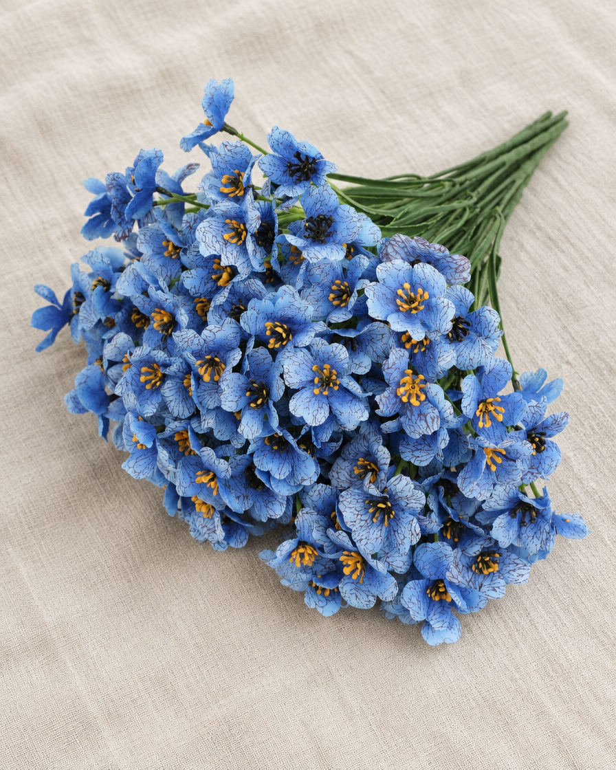 Blue Artificial Flower Bunch, shown alone on a linen background