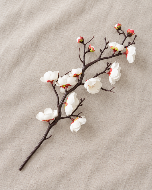 White Artificial Plum Blossom Single Branch, shown alone on a linen background